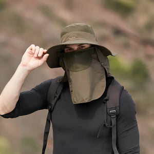 Um pescador mostrado de frente usando o Chapéu de Pesca Expedition Pro de aba larga e na cor verde militar, com destaque para seu protetor de rosto respirável