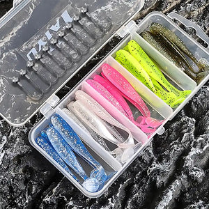 Kit de iscas artificiais soft shad com anzóis jighead exibido aberto em superfície rochosa com fundo escuro