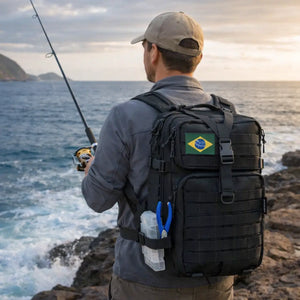 Um pescador de costas as margens de uma costeira de praia usando um boné e com a Mochila de Pesca MK preta nas costas
