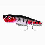 Isca Artificial Popper Pro X Foguinho mostrada do lado esquerdo, com todas as suas cores e sua garateia em foco